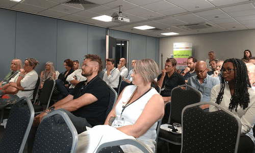A crowded room at a speaking event